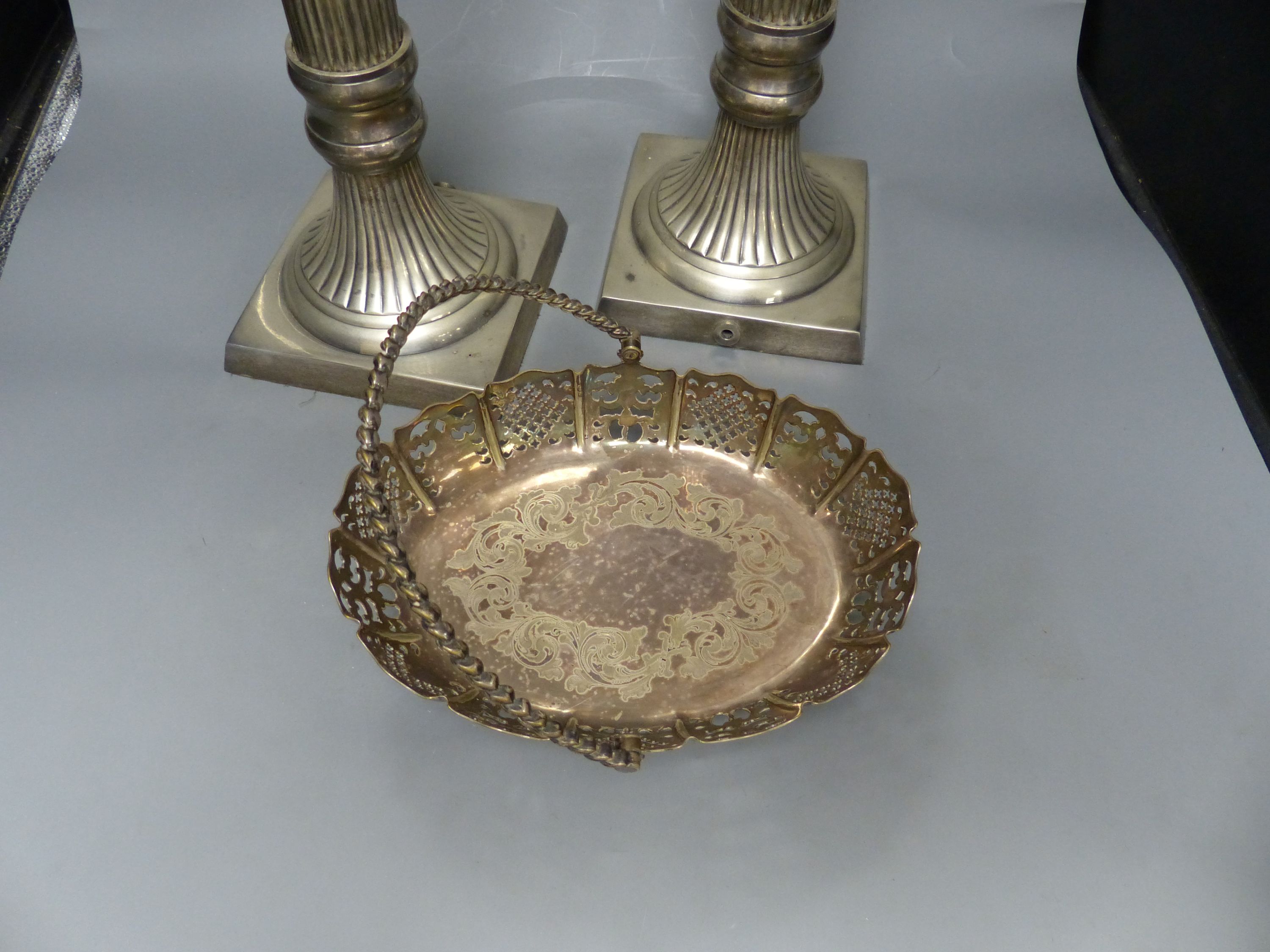A pair of large plated electric table lamps, each square base marked AWEP, and a plated cake basket